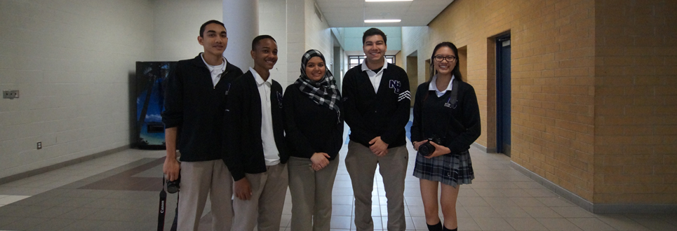 Three male students and two female students wearing their school uniforms